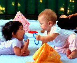 Two infants interacting during a RIE Parent Infant Guidance Class 